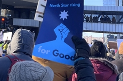 Photo of a protest with someone hold a sign saying "North Star Rising for Good."